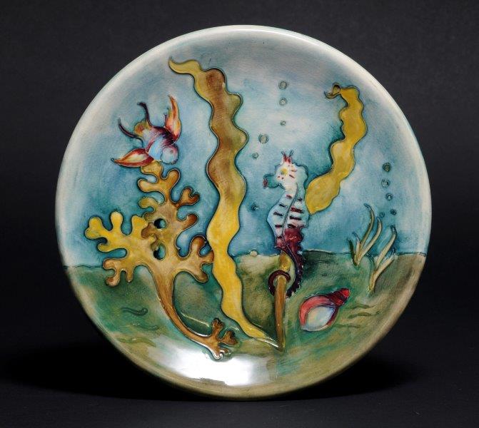 alt="Moorcroft plate sea horse fish and seaweed on blue and green background" 