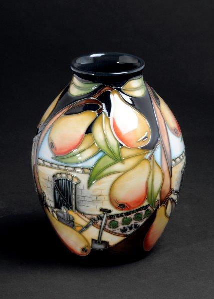 alt="Sian Leeper vase blush pears with leaves framing Cannon Hall walled garden scene"