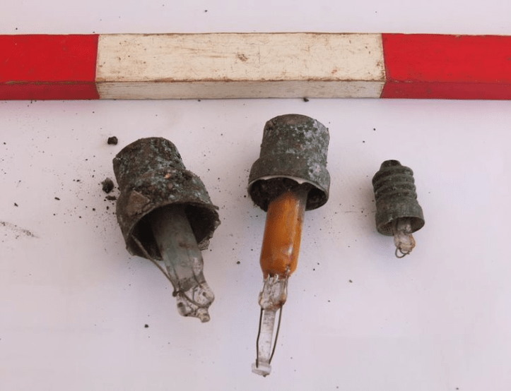 alt="three light bulbs with scale rule"