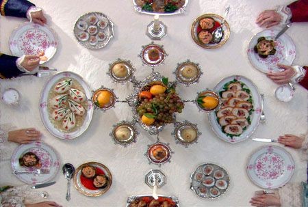 alt="decorative table setting with plates of food and fruit"