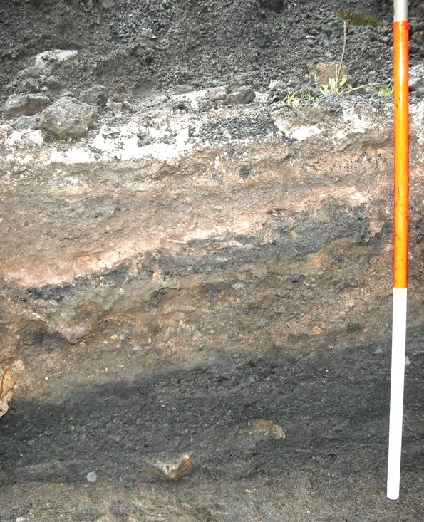 alt="earth in black and orange layers with scale rule up the side"