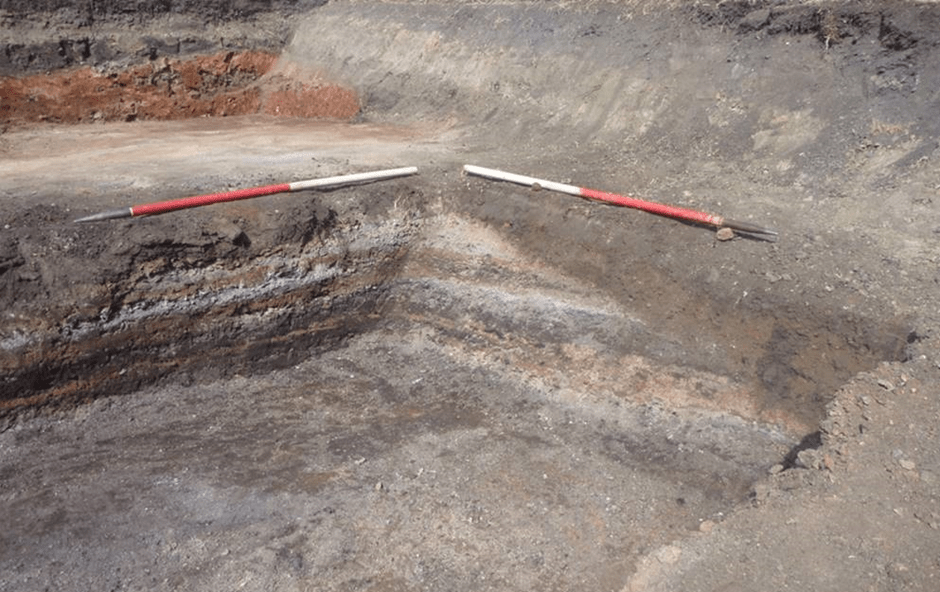 trench corner with different coloured layers and noticeable diagonal cut