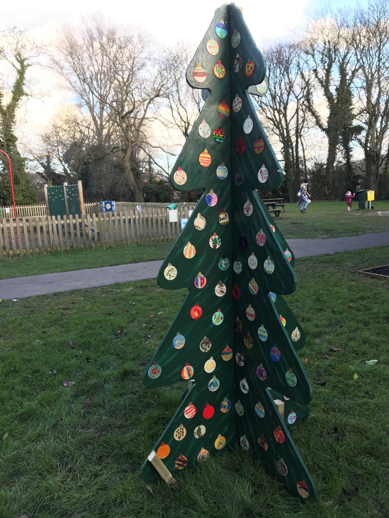Wooden Christmas tree in front of a children's playpark