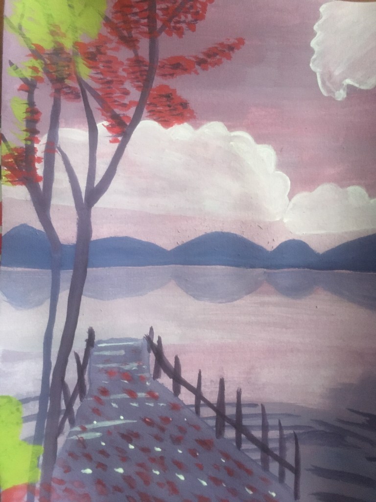 Picture of a lake with a tree and jetty in the foreground and hills in the distance. 