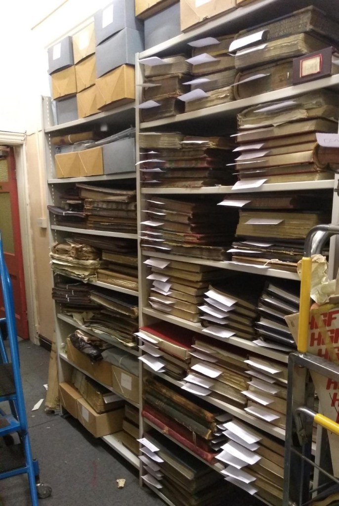 Shelves full of documents and boxes, all with labels, ready to be moved.