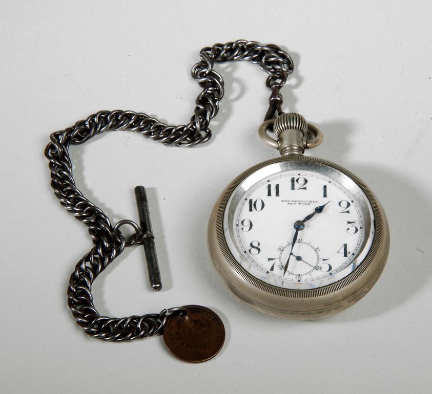 A round pocket watch with a metallic chian