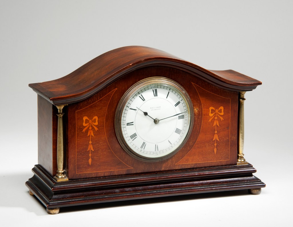 a small brown mantel clock 