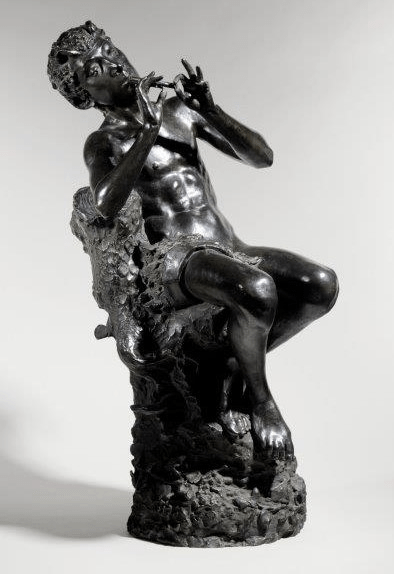A bronze figure of Pan playing pipes. The figure is a male fawn sitting on a tree trunk with ivy. It has a dark patina. Pan was from Greek mythology and was part human and part goat