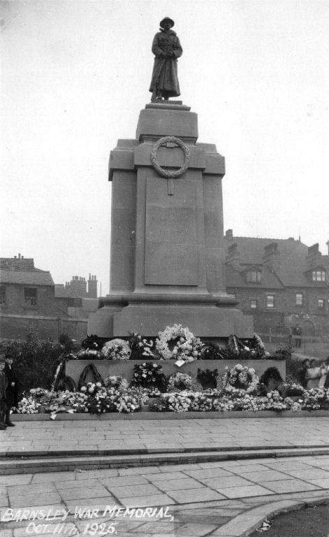 The memorial at the time of unveiling covered in floral tributes 