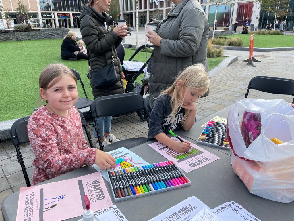 Two children working on their designs for the Eldon Beast