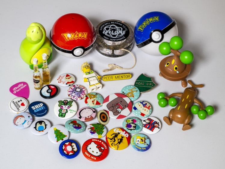 A collection of badges and pokemon memorabilia 