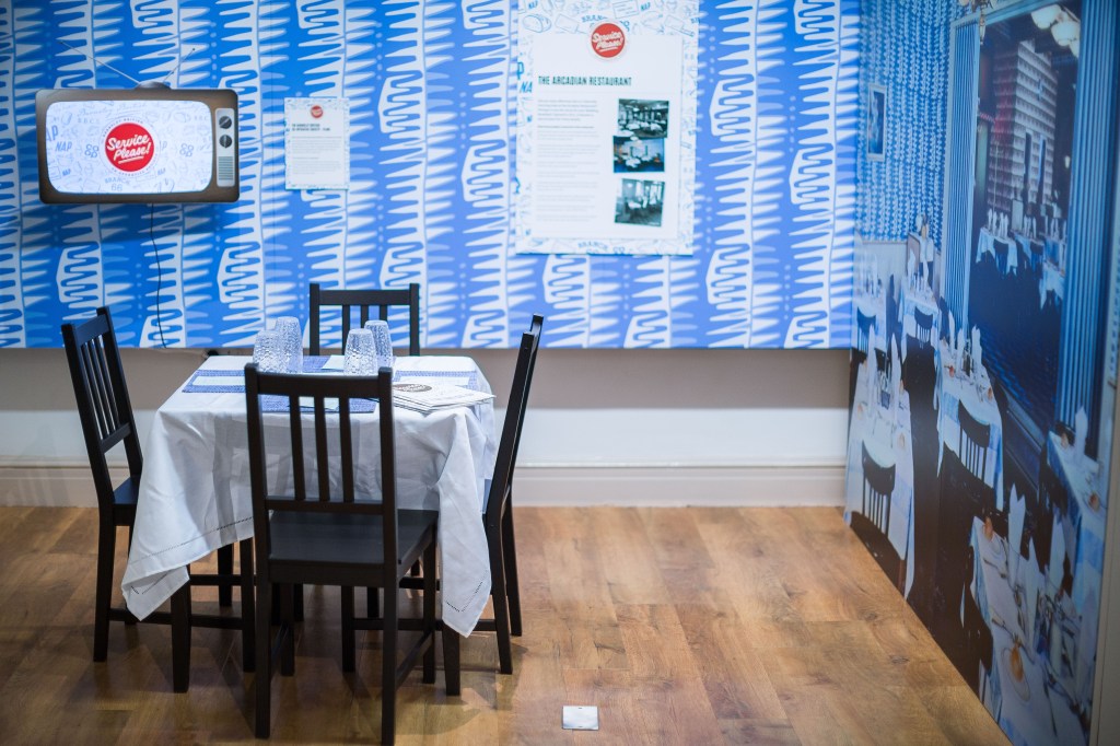 A view of the exhibition including a table and chairs