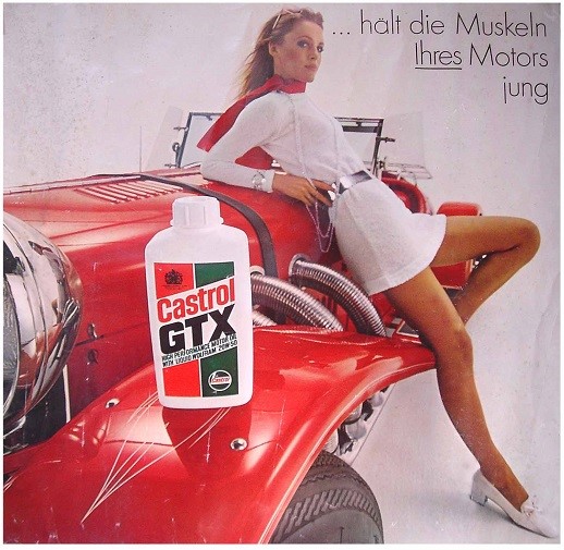 A Castrol GTX advertisement - Victoria is in a white dress posing on a red vehicle.