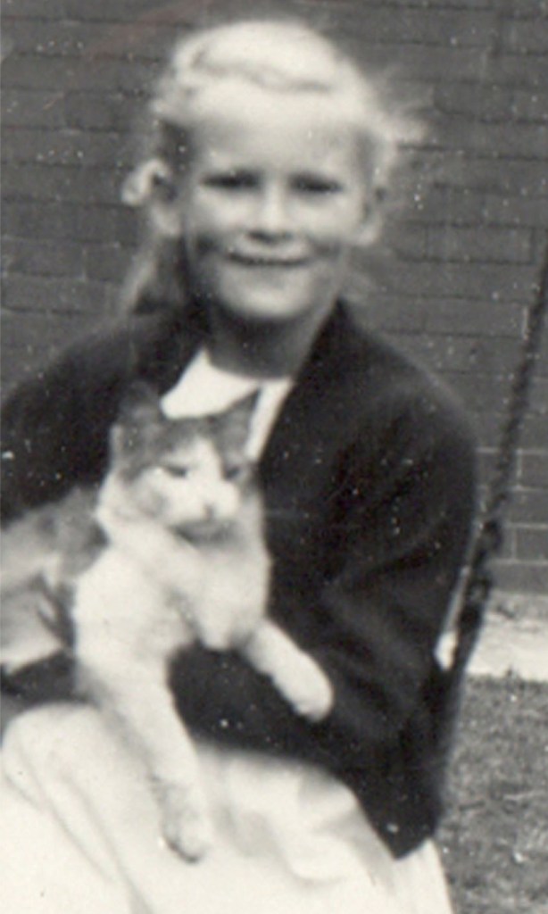 Victoria with a cat on her lap