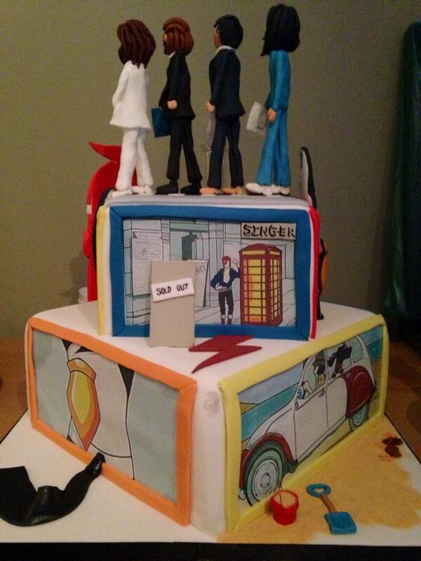 A cake with models of the four Beatles on the top