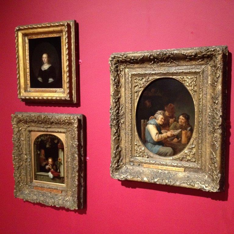 three of the framed paintings on display