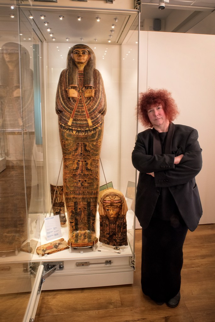 Joann Fletcher stood next to the exhibition case