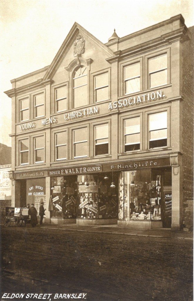 Photograph of the new YMCA building in Eldon Street c.1909. It has three shops on the ground floor and a sign between the first and second floor windows that says 'Young Men's Christian Association'