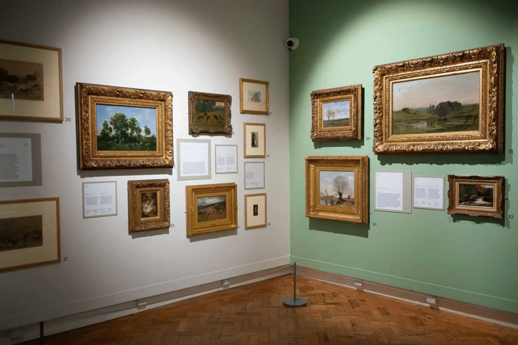 The Light and Soul exhibition, numerous paintings and drawings of varying sizes hanging on the wall.