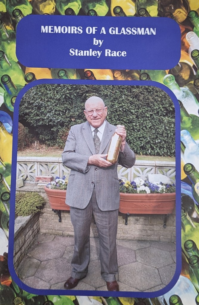 The front page of Stanley's memoirs. He is wearing a grey suit and holding a gold bottle