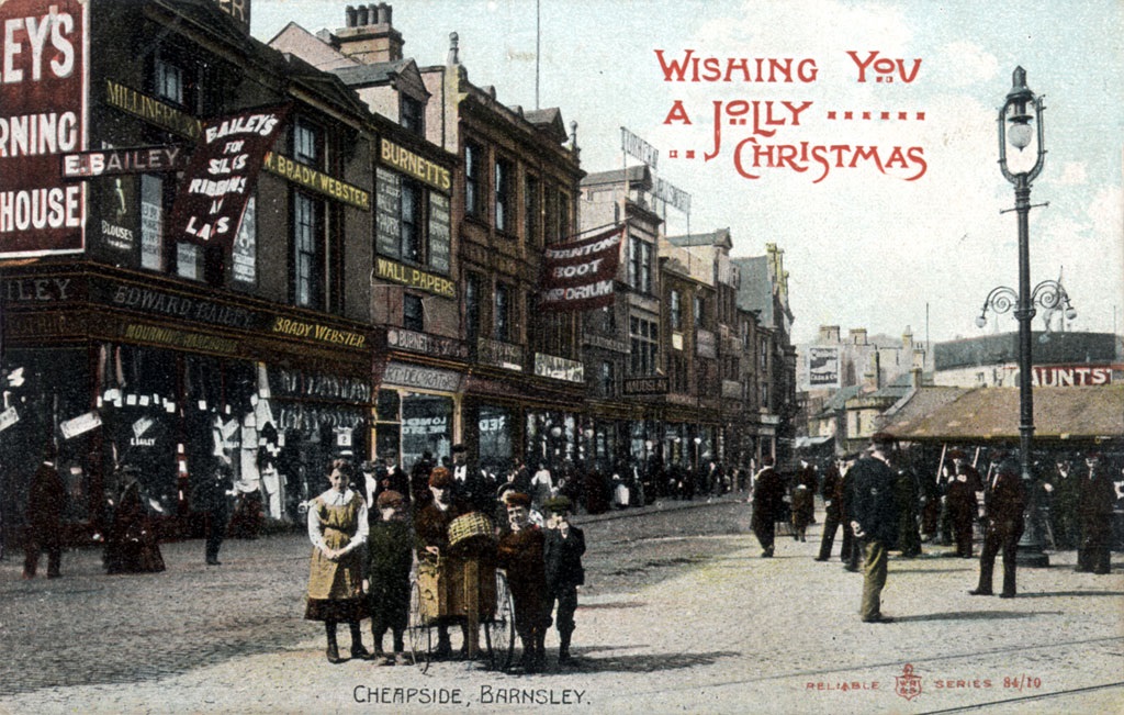 Historic Christmas card featuring a colourised photograph of Cheapside in Barnsley in the early 20th century. A message in the top right corner says Wishing you a jolly Christmas.