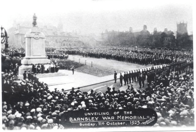 A crowd of people stood around the war memorial during the unveiling
