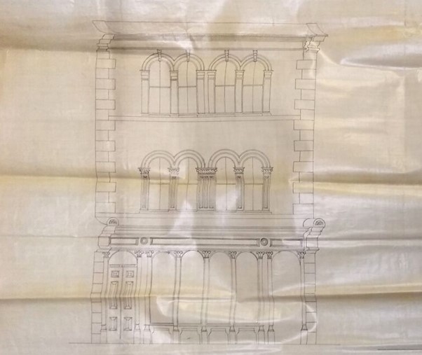 Architect's line drawing of a building frontage, showing a three storey building with 4 arch-headed windows on the first and second floor and a shopfront with 4 tall windows, a door and a passage-way opening on the ground floor.