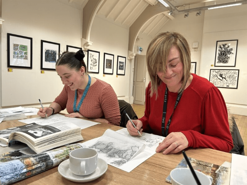 Two people sketching in the Cooper Gallery