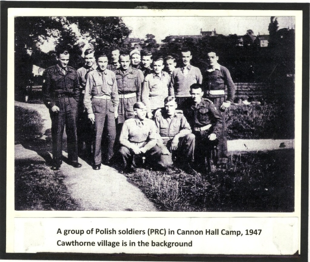 A black-and-white photo showing a group of Polish soldiers standing and kneeling outdoors at Cannon Hall Camp in 1947. They are dressed in uniform, with Cawthorne village visible in the background. A caption below provides details.