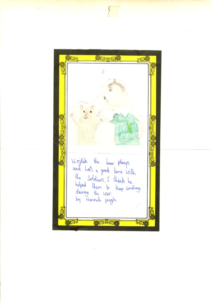 A child's drawing of a person in a green shirt petting a bear, with a yellow and black decorative border. Below the drawing, text reads: "Wright the bear plays and has a good time with the soldiers. I think he helped them to keep smiling during the war. by Hannah payh.