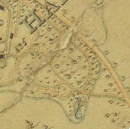 A vintage map with faint, hand-drawn lines and markings. It shows various numbered plots, a few structures, and some faint, curving lines likely indicating roads or pathways. There appears to be a small body of water towards the bottom right side of the map.