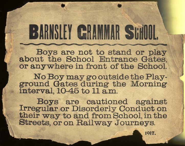 A weathered, torn notice from Barnsley Grammar School dated 1917. It instructs boys not to play near school gates, limits playground access to specific times, and warns against disorderly conduct on their way to school or during travel.