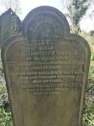 Gravestone of George Thomas Watson, son of John and Mary Watson, located in a churchyard, with detailed engraving and a decorative arch at the top.