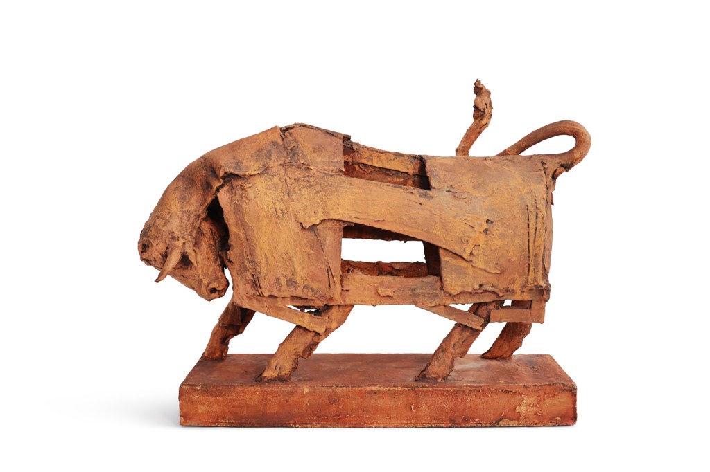 A ceramic sculpture of a bull, characterized by a deconstructed style and textured surface, showcasing earthy tones.
