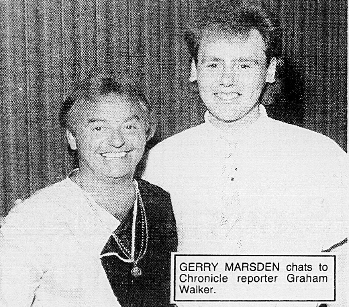 Gerry Marsden, of Gerry and The Pacemakers, poses for a photo with Chronicle reporter Graham Walker, both smiling at the camera.