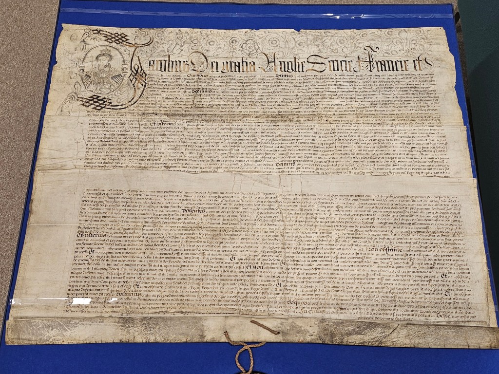 A 17th-century parchment document featuring intricate calligraphy and a royal seal, detailing the Grant of King James I to George Wood and John Broadhead concerning the Manor of Monk Bretton.