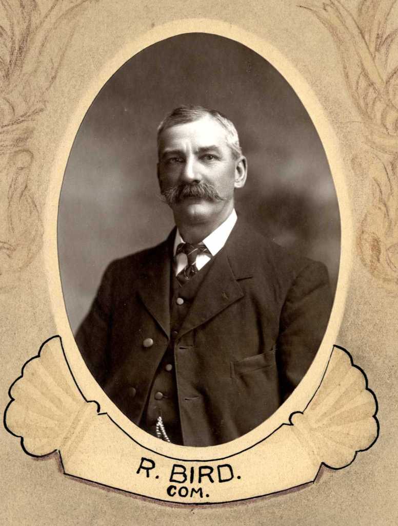 A historical portrait of R. Bird, a committee member, depicted in an oval frame with decorative elements.