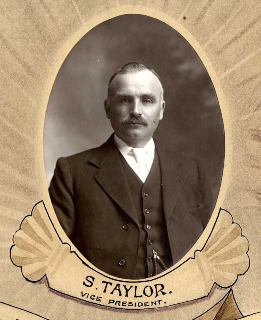 Portrait of S. Taylor, Vice President of the Working Men's Club, displaying a formal attire with a mustache.