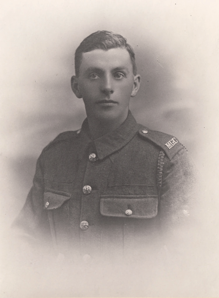 A historical portrait of a young soldier in military uniform, suggesting early 20th century attire.