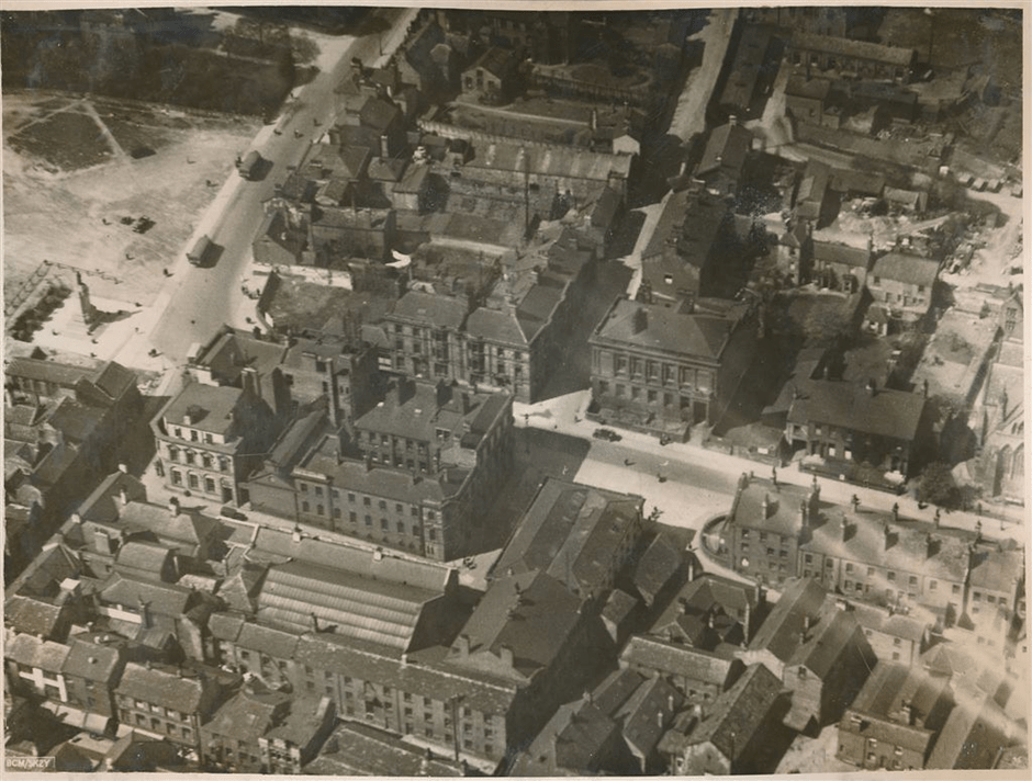 Aerial view of Barnsley town centre, showcasing historic buildings and streets, with some areas under construction.