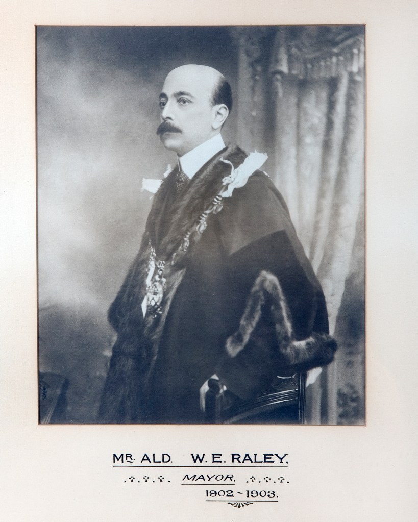 Black and white portrait of Mr. Ald. W.E. Raley, the Mayor of Barnsley from 1902 to 1903, wearing a ceremonial robe and chain of office, seated with a thoughtful expression.