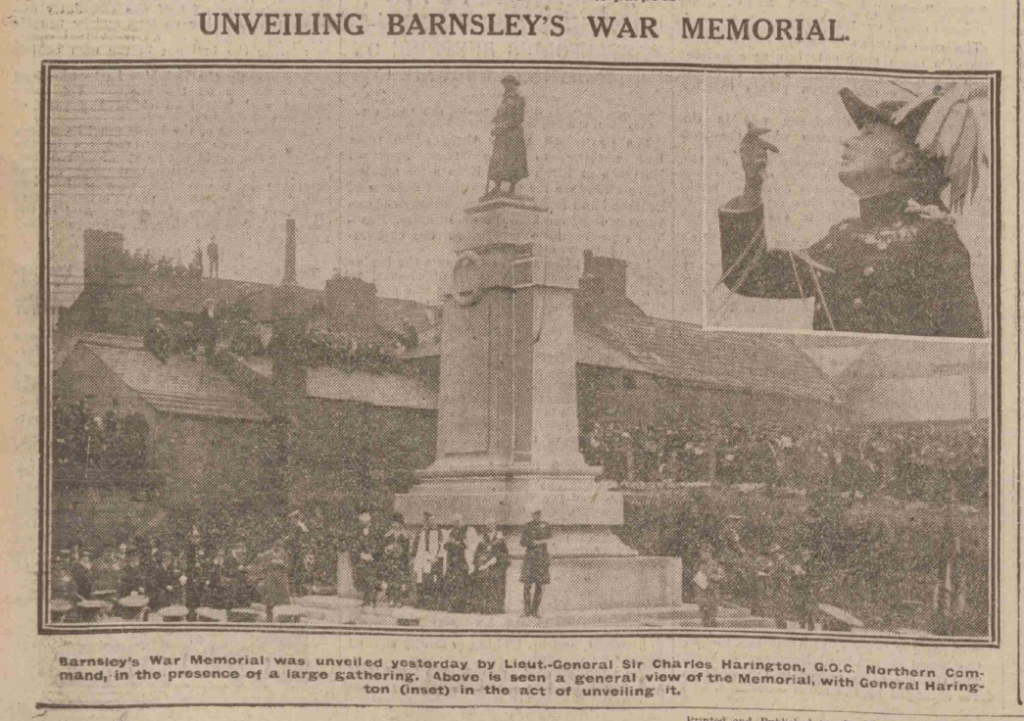 Historical image of the unveiling ceremony of Barnsley's War Memorial, featuring a large crowd gathered around the memorial, with Lieutenant General Sir Charles Harington officiating the event.
