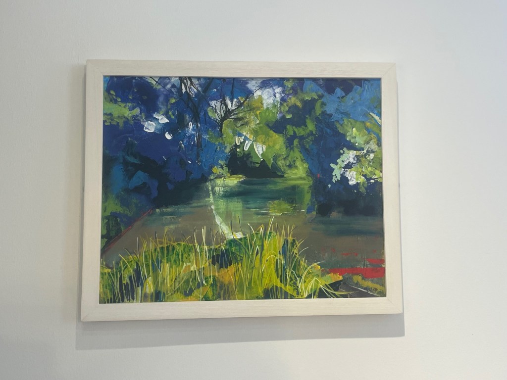 A vibrant landscape painting featuring a pond surrounded by lush greenery and foliage, with a mix of blue and green hues.